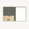 tan and brown pattern clipfolio with brown interior pocket and lined pad on a cream background