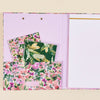 open floral clipfolio, notebooks inside liner, notepad, being background