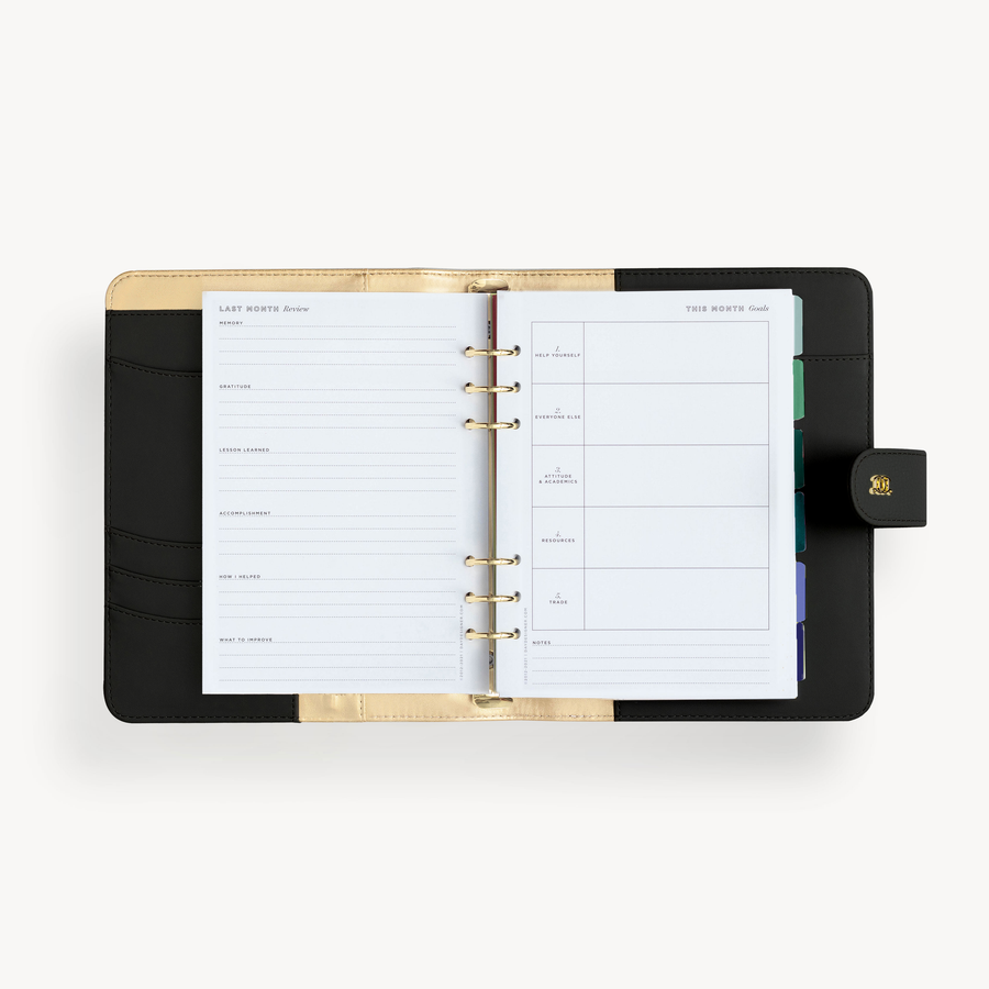 A5 black binder open to show black and gold lining with goal setting pages