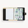 Black A5 binder open to show black and gold liner with notes page and colorful stickers