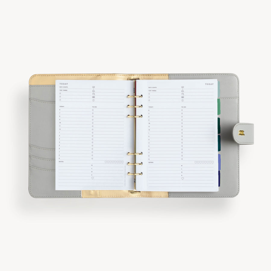 A5 gray binder open to show gray and gold liner with daily pages
