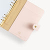 A5 blush binder open to show gold and blush interior with pocket and binding rings.