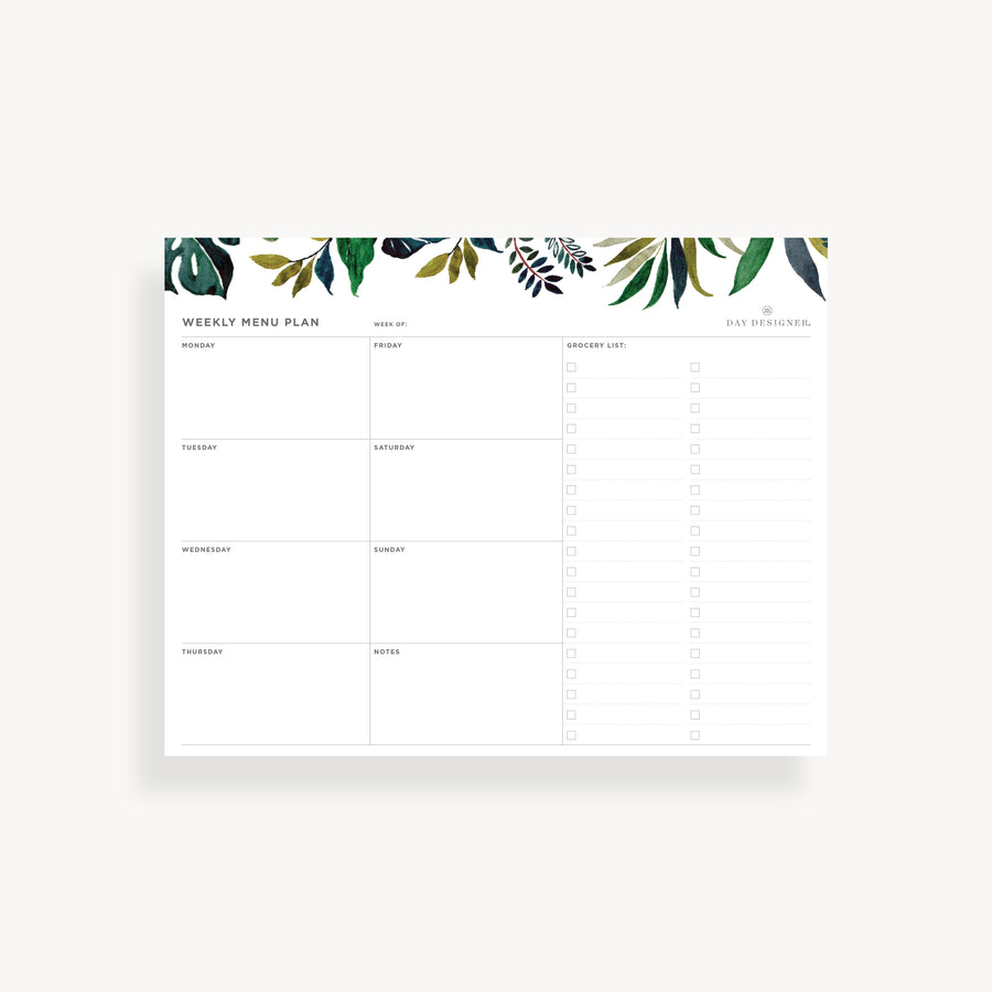 Menu planning pad with green leaf pattern on a white background