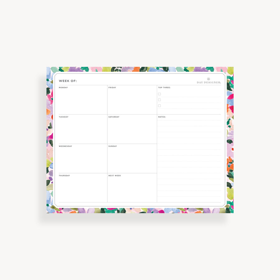 weekly planning pad with colorful floral border on a white background