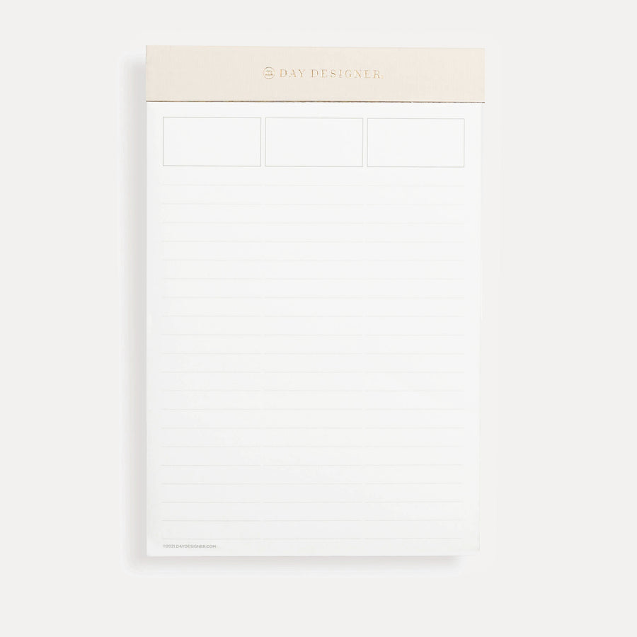 Planning pad with blush and gold trim with lined notepad layout.