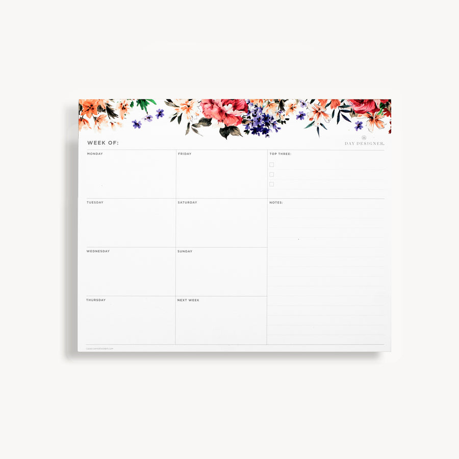 weekly planning pad with a floral illustration on a white background