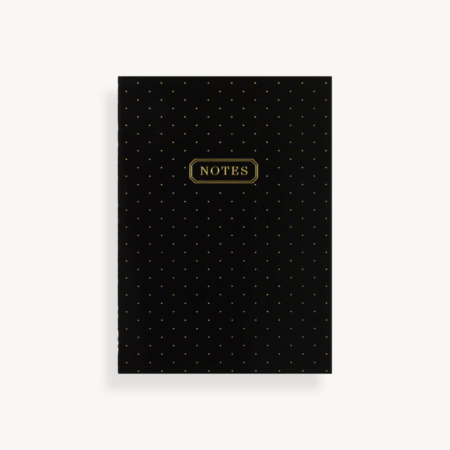 slim mini notebook with black swiss dot pattern cover and gold accents 