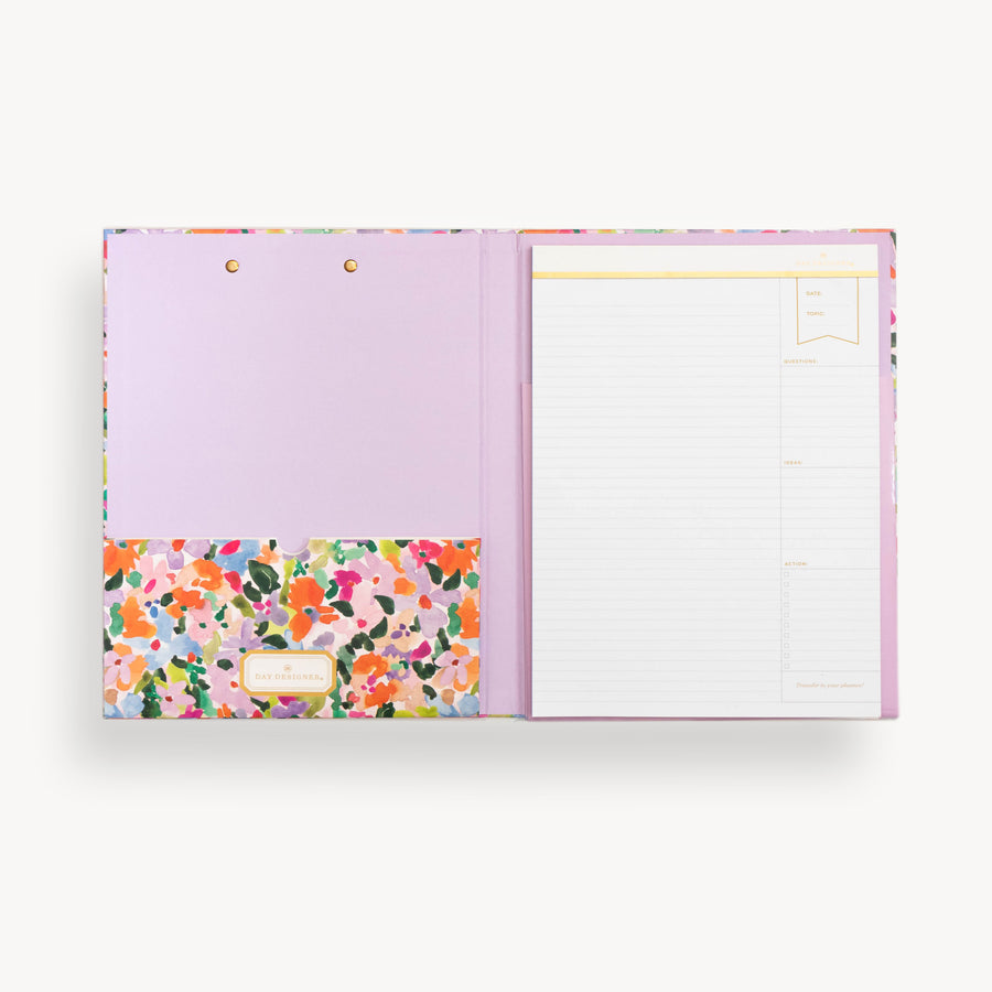 colorful floral pattern clipfolio with lavender interior pocket and lined pad on a cream background