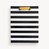 black and white stripe pattern clipfolio with gold clip on a cream background