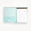 black and white stripe pattern clipfolio with mint interior pocket and lined pad on a cream background