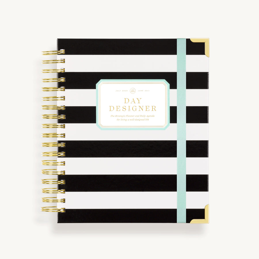 black and white planner with mint elastic band attached