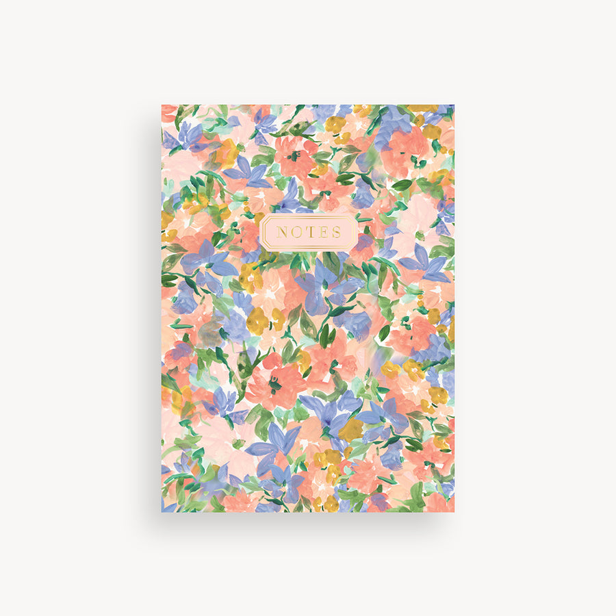 slim mini notebook with painted floral pattern cover and gold accents 