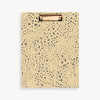 tan and brown pattern clipfolio with gold clip on a cream background