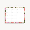 weekly planning pad with pink and green floral border on a white background