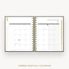 An open tabbed monthly calendar planner shown from the front, with January 2027 visible on the right page and a gold-toned spiral binding down the center. The pages are white with gray grid lines and small gold decorative accents along the left and right edges.