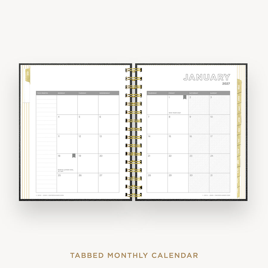 An open tabbed monthly calendar planner shown from the front, with January 2027 visible on the right page and a gold-toned spiral binding down the center. The pages are white with gray grid lines and small gold decorative accents along the left and right edges.