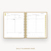 An open spiral-bound daily planner showing two lined daily planning pages with gold-toned binding and gold page edges, centered on a light gray background with the text 'DAILY PLANNING PAGE' below.