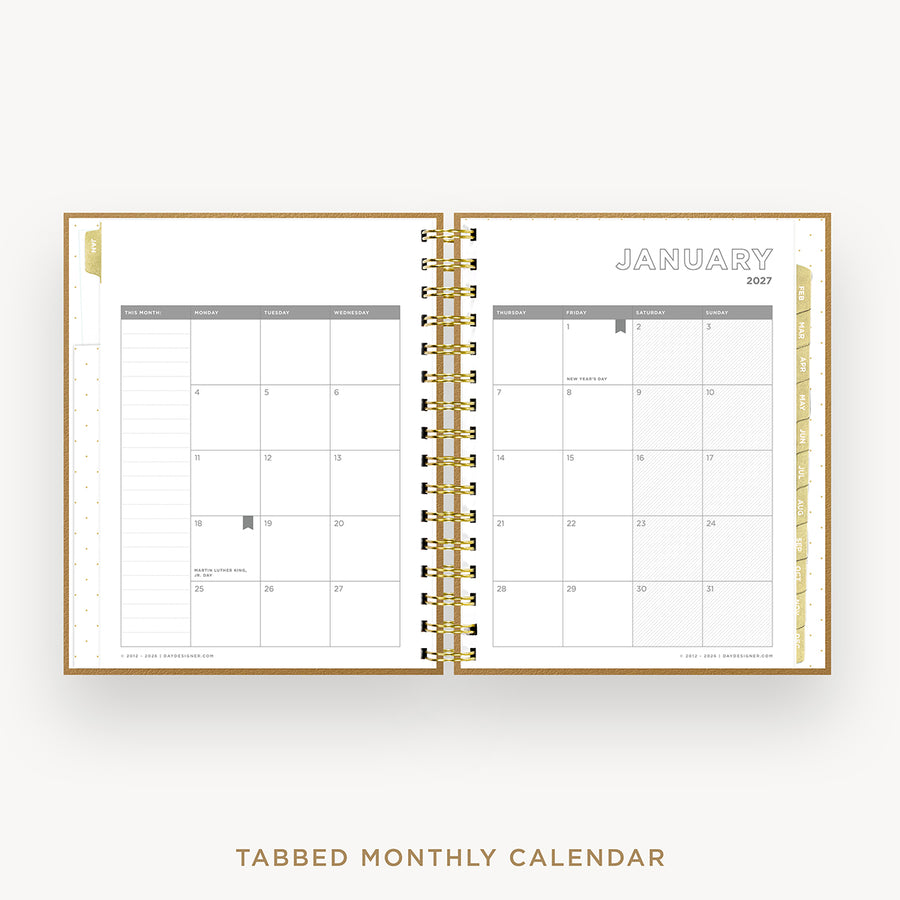 An open spiral-bound monthly calendar planner shown from above on a light gray background. The pages are white with gray grid lines and headers, and the center binding is gold.