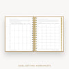 An open spiral-bound planner or notebook showing two printed goal-setting worksheet pages, with a gold wire binding and gold text at the bottom reading 'GOAL-SETTING WORKSHEETS' on a light gray background.