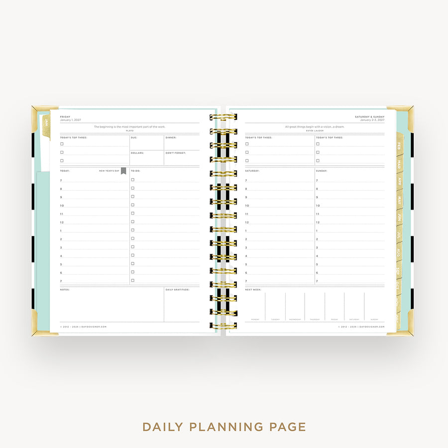 An open daily planner spread showing two lined daily planning pages with gold spiral binding and pastel accent tabs, photographed on a light gray background with the text 'DAILY PLANNING PAGE' below.