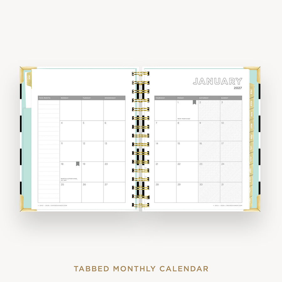 An open tabbed monthly calendar planner shown from above on a light gray background. The pages are white with gold spiral binding and a mint green left tab.