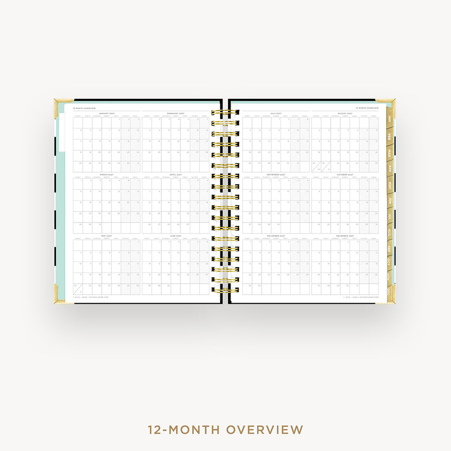 An open spiral-bound planner showing a 12-month overview calendar spread on a light gray background, with the text '12-MONTH OVERVIEW' below.