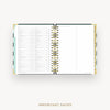 An open spiral-bound planner or agenda showing a detailed monthly calendar page with columns for days, dates, and notes. The planner has a white interior, gold-toned rings and edges, and a light aqua accent tab on the left side, photographed on a clean white background with the text 'IMPORTANT DATES' below.