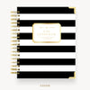 Black and white striped notebook with gold accents on a white background