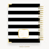 Spiral-bound notebook with black and white striped cover and gold accents on a white background