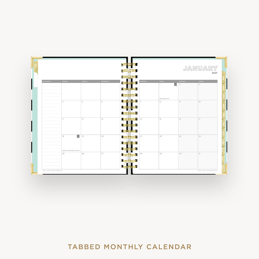 An open tabbed monthly calendar planner on a light gray background, showing a January 2027 calendar spread with gold spiral binding and pastel page accents. Text below reads 'TABBED MONTHLY CALENDAR'.