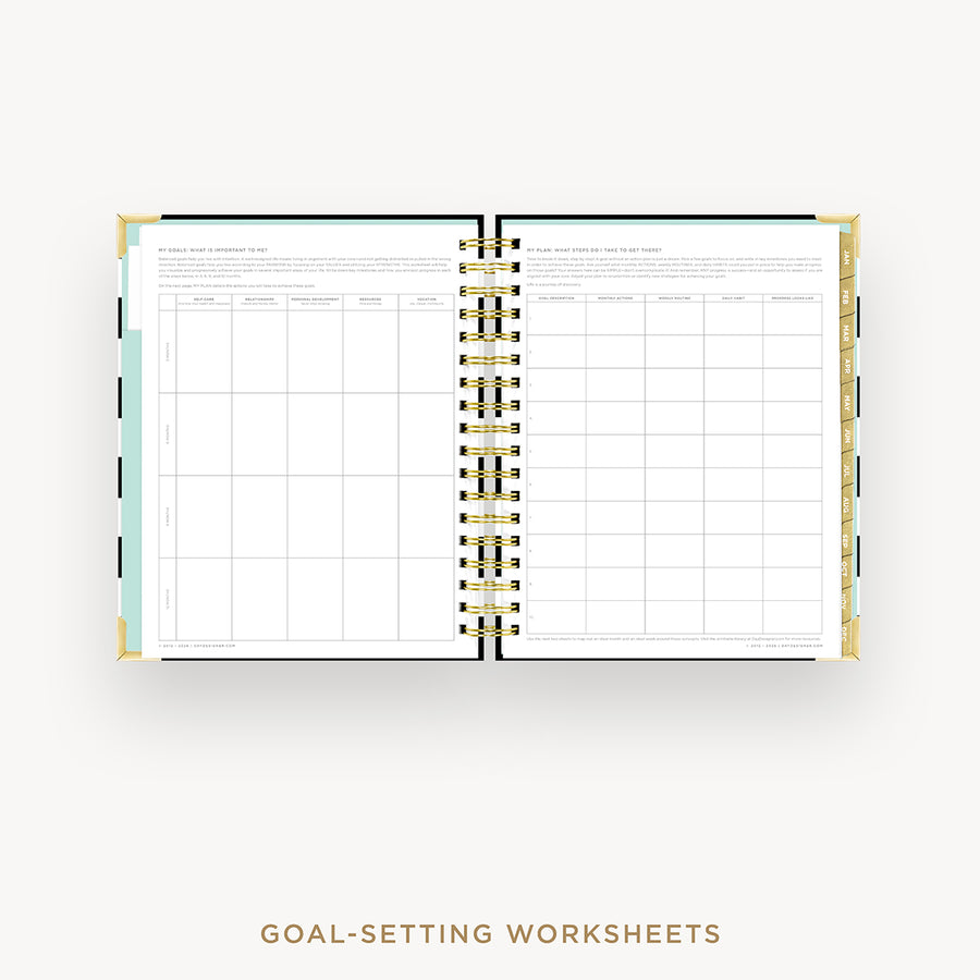 An open spiral-bound planner or notebook showing goal-setting worksheet pages on the left and a monthly calendar grid on the right, with decorative gold rings and a light blue accent tab on a white background. Text below reads 'GOAL-SETTING WORKSHEETS'.
