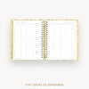 An open spiral-bound planner or notebook with two large white pages featuring a gift ideas to remember grid, shown on a light gray background with the title 'GIFT IDEAS TO REMEMBER' below.