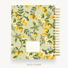 A spiral-bound notebook shown from the back cover, featuring a botanical pattern of lemons, white flowers, blue berries, and green leaves on a pale sage background. The notebook has a gold spiral binding and is displayed on a clean white background with the text 'BACK COVER' underneath.