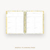 An open spiral-bound weekly planner with white pages, gold-toned binding, and a subtle floral patterned cover, shown on a light gray background with the text 'WEEKLY PLANNING PAGE' below.