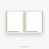 An open spiral-bound planner showing the Expenses page with lined columns, photographed on a clean white background with the word EXPENSES below.