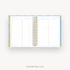 An open spiral-bound planner or agenda showing a favorites list page layout, photographed on a clean light gray background with the words 'FAVORITES LIST' below.