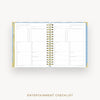 An open spiral-bound planner or checklist book showing the Entertainment Checklist page, photographed on a light gray background with the text 'ENTERTAINMENT CHECKLIST' below.