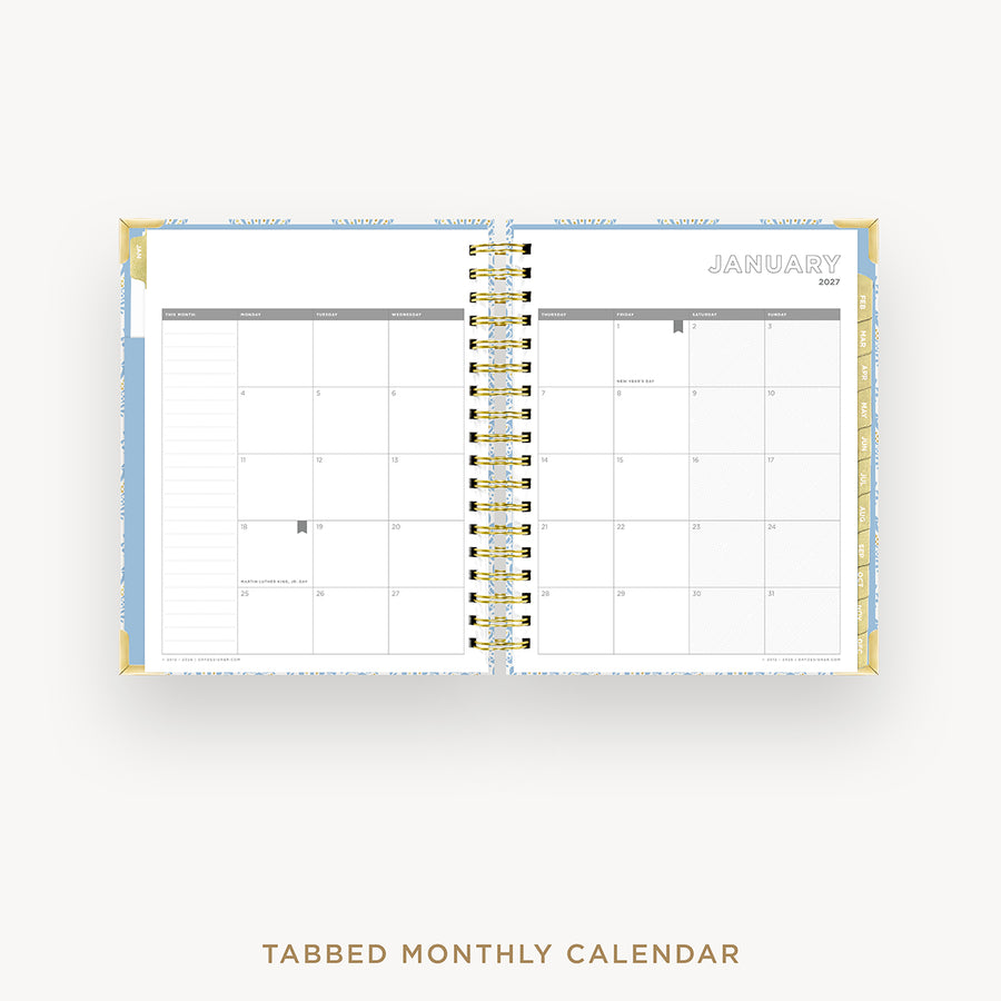 An open tabbed monthly calendar planner on a light gray background, showing the January 2027 page spread with gold spiral binding and blue page borders.