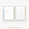 An open spiral-bound booklet or instruction manual with printed text pages, shown on a light gray background. The cover has a pale blue and gold pattern, and the bottom of the image includes the text 'INTRODUCTION & INSTRUCTIONS'.