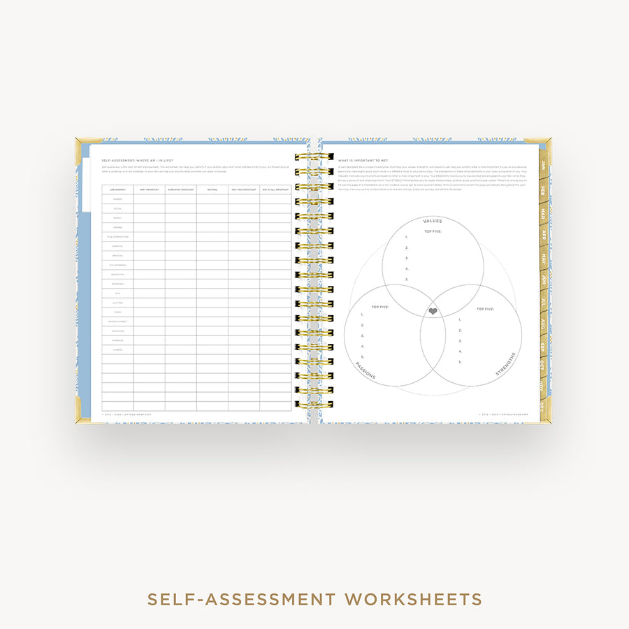 An open spiral-bound workbook showing self-assessment worksheet pages with tables and a Venn diagram, photographed on a light gray background with the text 'SELF-ASSESSMENT WORKSHEETS' below.