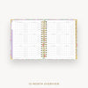 An open 12-month spiral planner or calendar showing a monthly overview layout, photographed on a clean white background with the text '12-MONTH OVERVIEW' below.