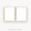 An open spiral-bound thank you note record planner with lined pages, gold rings, and a pastel floral patterned cover, shown on a light gray background with the text 'THANK YOU NOTE RECORD' below.