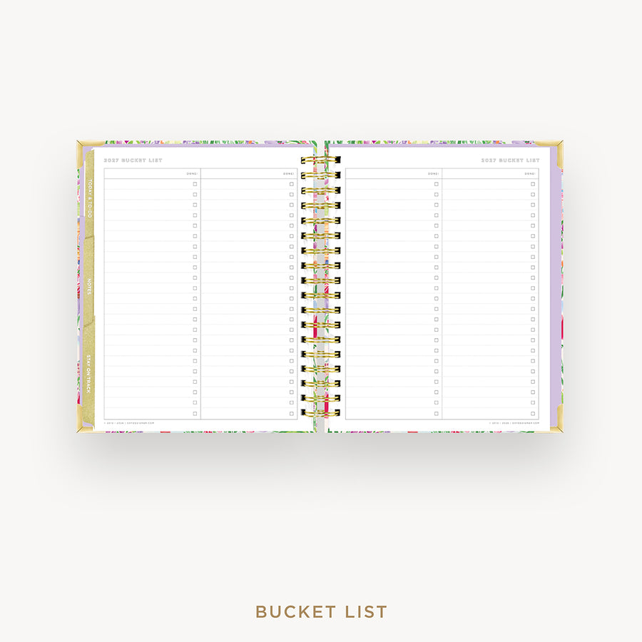 An open spiral-bound bucket list planner shown on a light gray background, with lined pages, a floral-patterned cover, and gold-toned rings. The text 'BUCKET LIST' appears below the product.