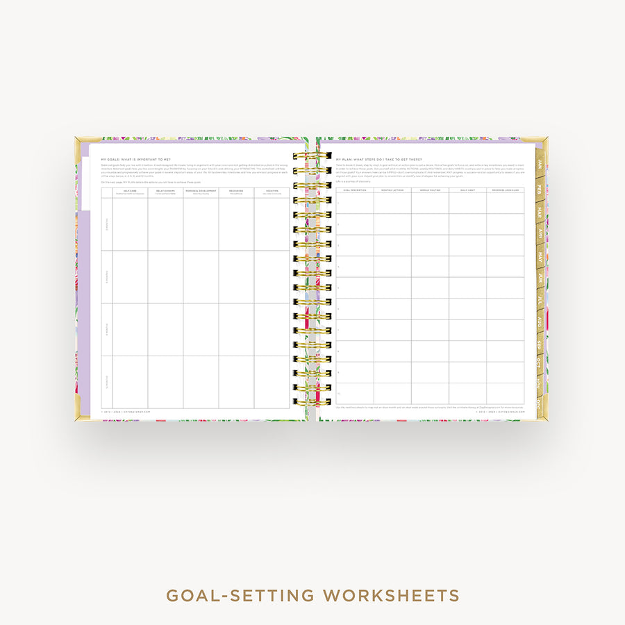 An open spiral-bound planner or agenda showing printed goal-setting worksheet pages, photographed on a light gray background with the text 'GOAL-SETTING WORKSHEETS' below.