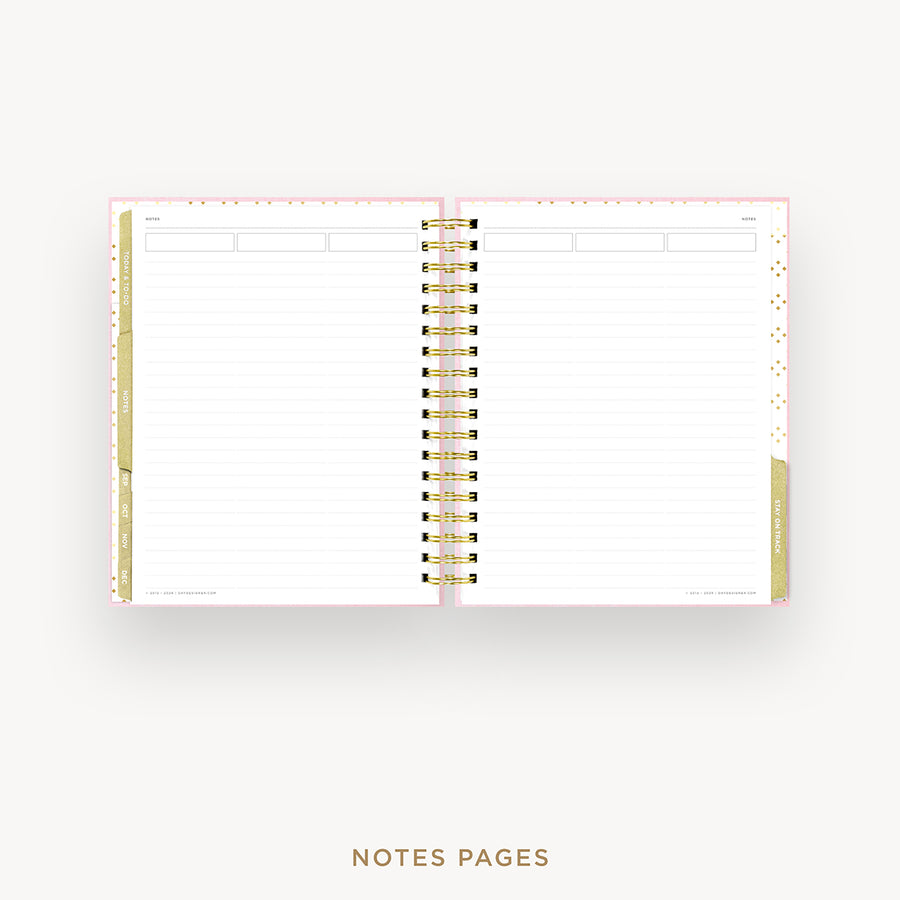 An open spiral-bound planner or notebook showing lined notes pages with gold and pink accents, centered on a light gray background with the text 'NOTES PAGES' below.