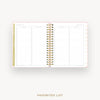 An open spiral-bound planner or agenda showing a favorites list page with columns for date, event, and notes. The pages are white with light pink borders and gold accents, set against a very light gray background with the words 'FAVORITES LIST' below.