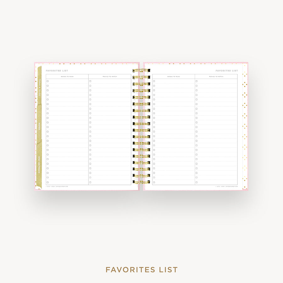 An open spiral-bound planner or agenda showing a favorites list page with columns for date, event, and notes. The pages are white with light pink borders and gold accents, set against a very light gray background with the words 'FAVORITES LIST' below.