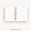An open spiral-bound planner or notebook showing a packing checklist page spread, with pink and white pages and gold accents, on a light gray background. The text 'PACKING CHECKLIST' appears below.