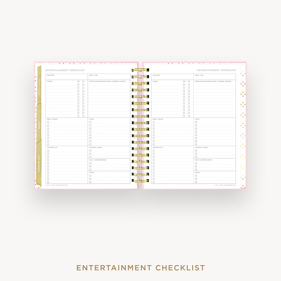 An open spiral-bound planner showing an Entertainment Checklist page, displayed on a light gray background with the text 'ENTERTAINMENT CHECKLIST' below.