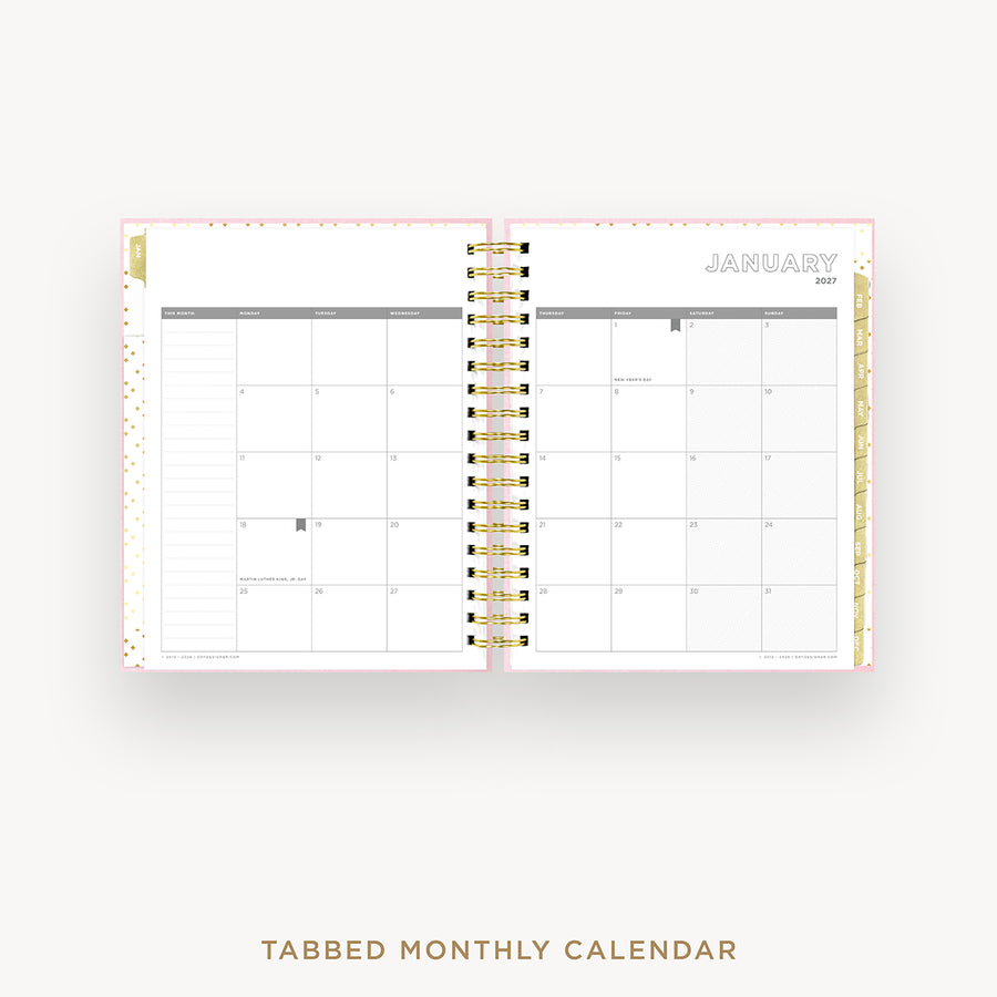 An open spiral-bound monthly calendar planner on a light gray background, showing a January 2027 calendar spread with white pages, gray grid lines, and gold accents. The text 'TABBED MONTHLY CALENDAR' appears below.